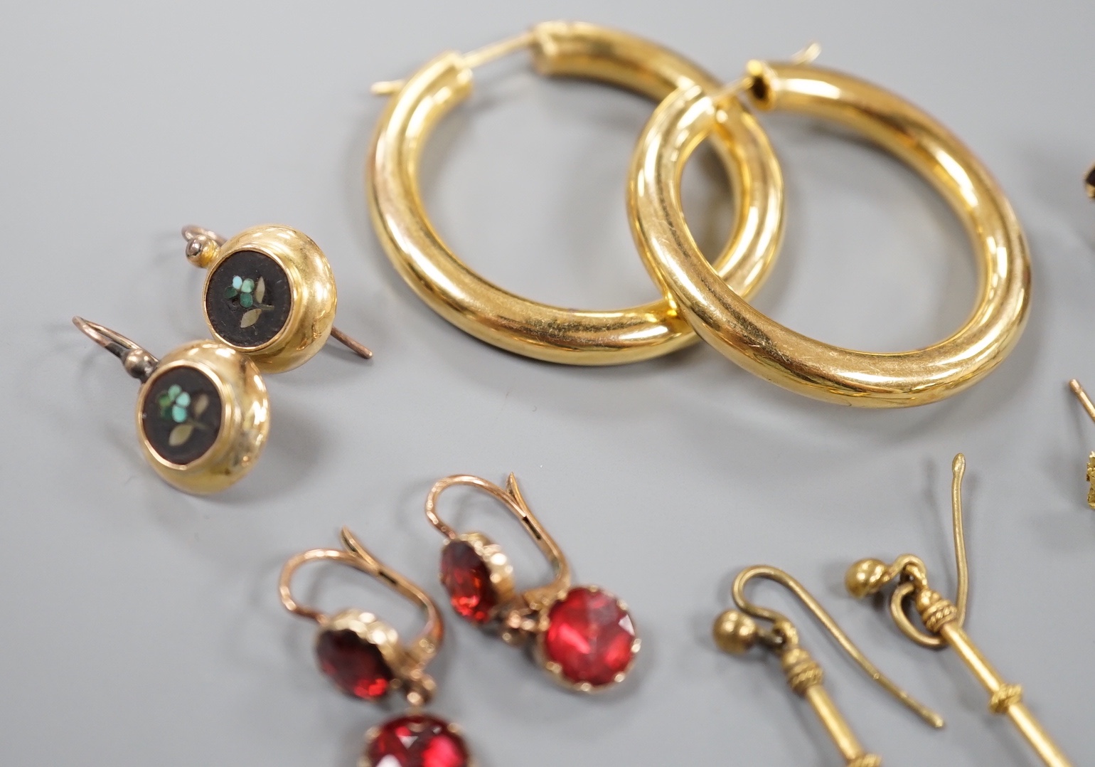 Eight assorted pairs of yellow metal or yellow metal and gem set earrings, including two pairs of Victorian garnet set, coral bead set, nugget and 9ct gold hoop